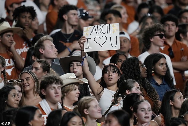 A fan holds a sign for Texas quarterback Arch Manning (16) during the first half on Saturday.