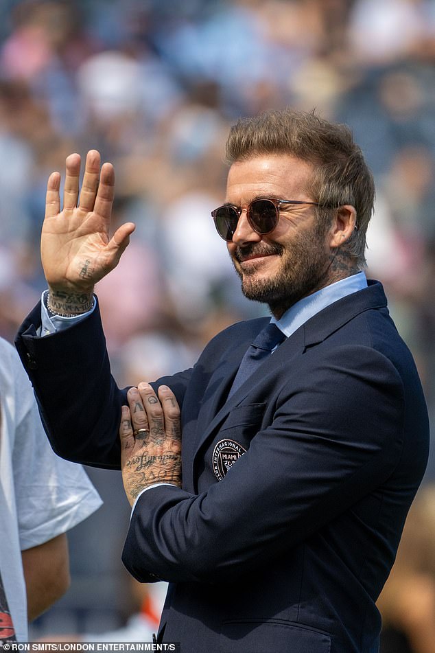 He paired his team suit with a pale blue shirt, a navy tie and a pair of trendy sunglasses.