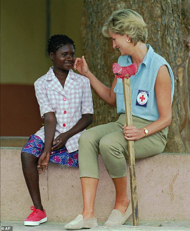 Diana is seen speaking to 13-year-old amputee Sandra Thijica in Angola during a visit in an effort to raise awareness about landmines in 1997.