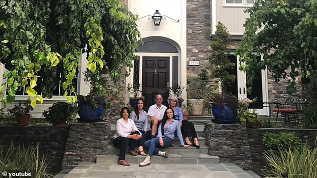 Leach is pictured with his parents outside their former home in San Diego, which they sold to buy the castle.