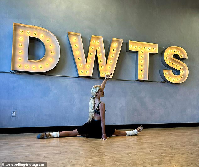 The Beverly Hills 90210 star, 51, who was announced as a contestant on the dance competition show earlier this month, took to Instagram on Saturday to show off her flexibility as she posed behind an illuminated DWTS sign.