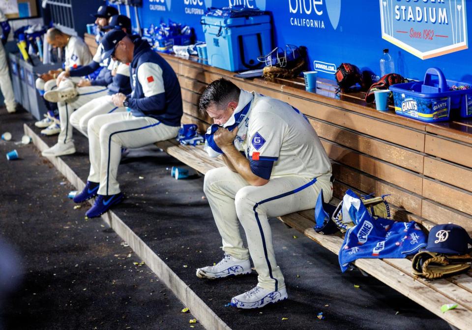 Dodgers reliever Daniel Hudson sits in the dugout after allowing a two-run homer to Colorado's Charlie Blackmon.