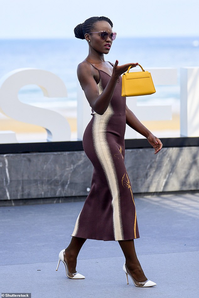 Lupita turned heads as she made her way to the stage, as she arrived sporting a pair of pink cat-eye sunglasses and a mustard-colored mini handbag to carry her ensemble.