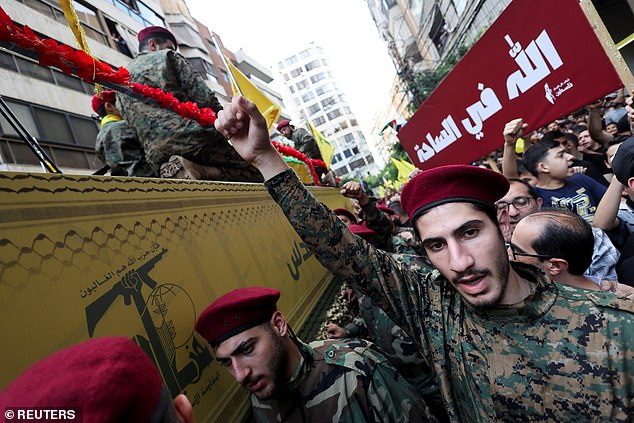 A man gestures at the funeral of Hezbollah leader Ibrahim Aqil