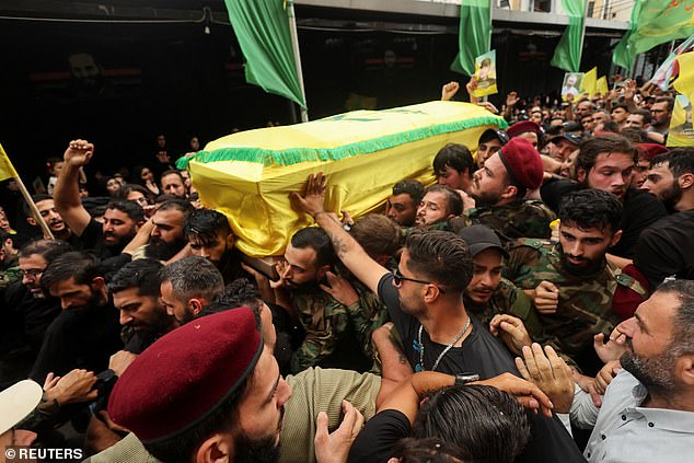 Mourners carry a coffin during the funeral of Hezbollah leader Ibrahim Aqil and Hezbollah member Mahmoud Hamad