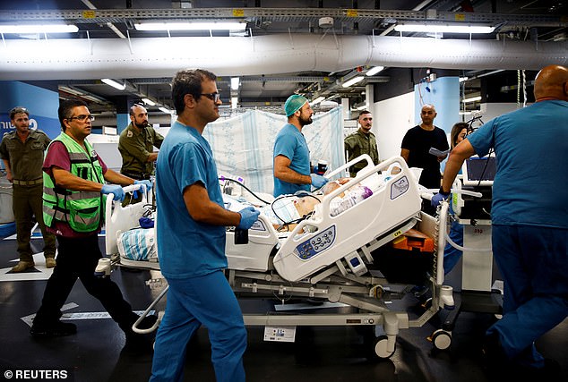 Medical staff move a patient's bed into an underground emergency hospital in a parking lot of the Rambam Healthcare Campus, amid cross-border hostilities between Hezbollah and Israel, in Haifa, Israel, September 22, 2024