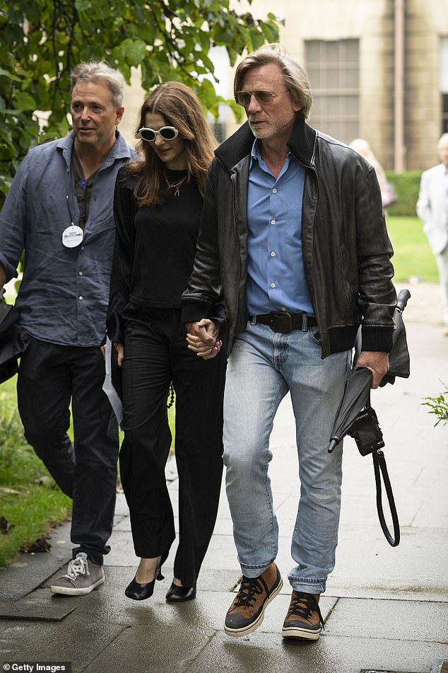 Rachel donned baggy black trousers and a matching jumper and completed her look with a pair of black court shoes and statement black and white sunglasses.