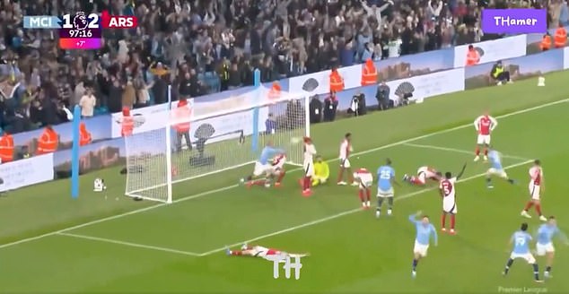 The ball bounces off Gabriel's head as City players celebrate the equaliser.