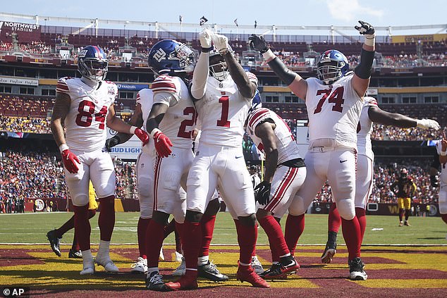 Nabers and his teammates celebrate after one of his two first-half touchdowns against the Browns.