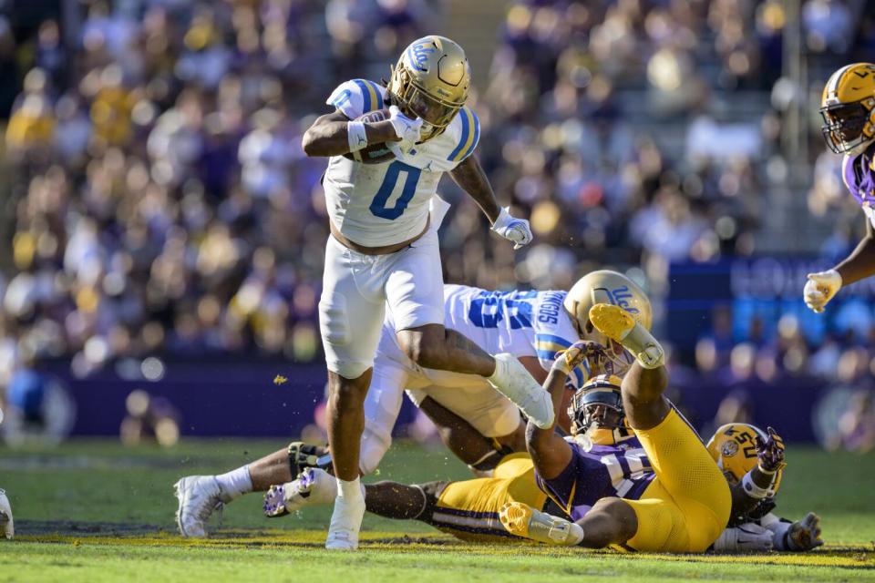 UCLA running back Jalen Berger (0) runs for a gain after breaking a tackle