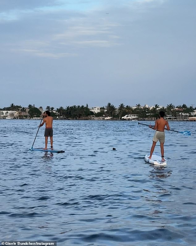 The 44-year-old CAA Fashion model, who boasts 35.1 million followers on social media, posted a rare photo of her 14-year-old son, Benjamin Rein Brady (right), paddleboarding with her boyfriend Joaquim Valente (left), who were photographed wearing the exact same shorts on June 17.