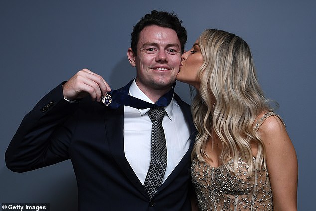 Lachie Neale's wife Julie kisses him on the cheek after the Lions midfielder took out the 2020 Brownlow tally