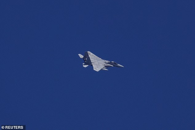 An Israeli plane flies amid cross-border hostilities between Hezbollah and Israel, as seen from northern Israel, September 23, 2024