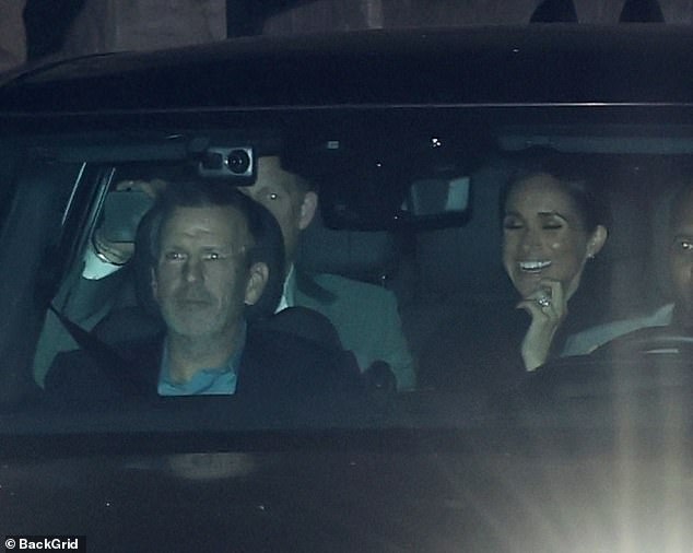 Prince Harry and a smiling Meghan Markle are seen leaving a fashion event 