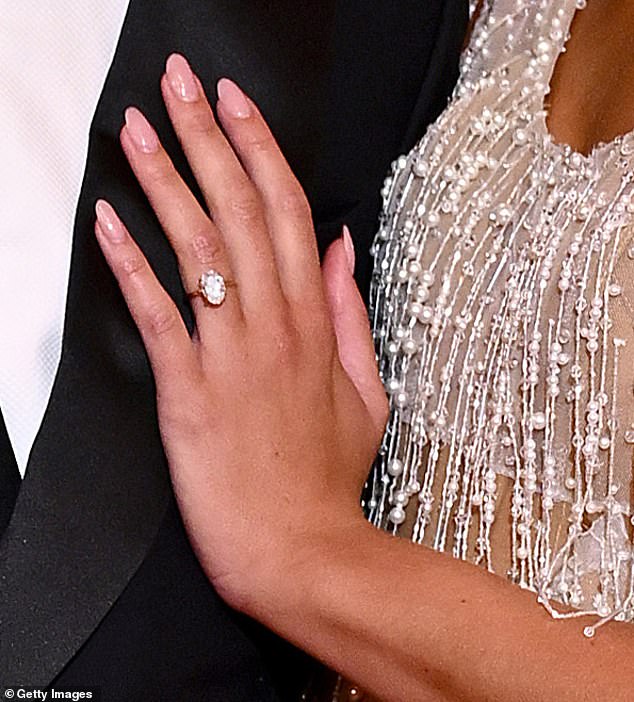 The oval cut of the jeweler matched her dress covered in pearls and jewels.