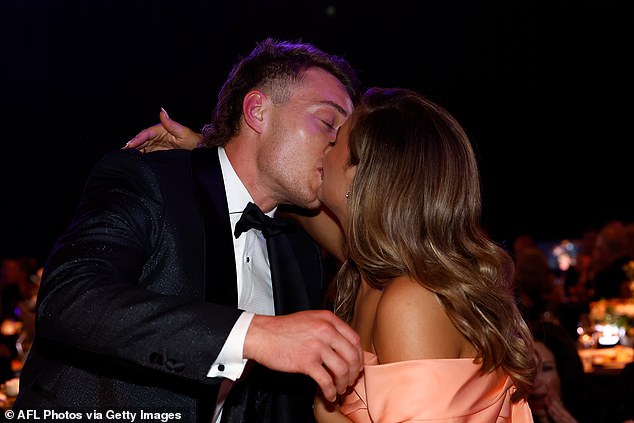 Cripps is kissed by his wife Monique after being named the winner of the prestigious award.