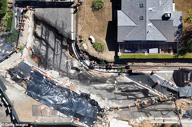 The coastal community has been plagued by landslides since torrential rains hit the area in spring last year. (Pictured: Aerial view of damage in Rancho Palos Verdes)