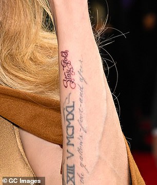 Angelina's tattoo that says 'Stay Gold' is located on the side of her arm, near two other tattoos, in cursive; seen on April 11 in New York City