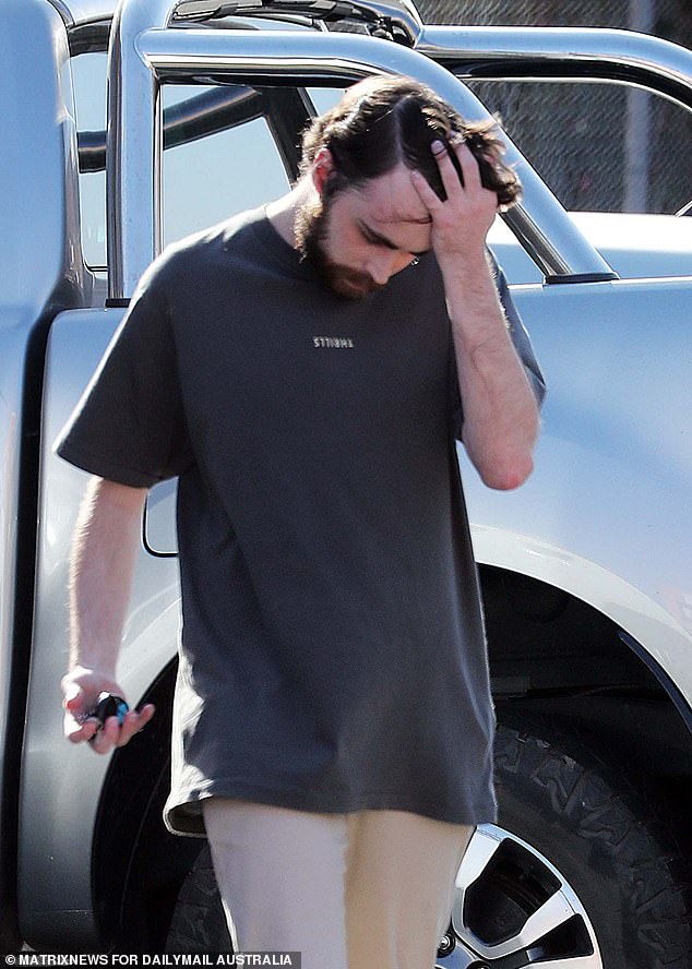 The young policeman, sporting a scruffy beard, pushed his long hair away from his face as he made his way to his appointment.