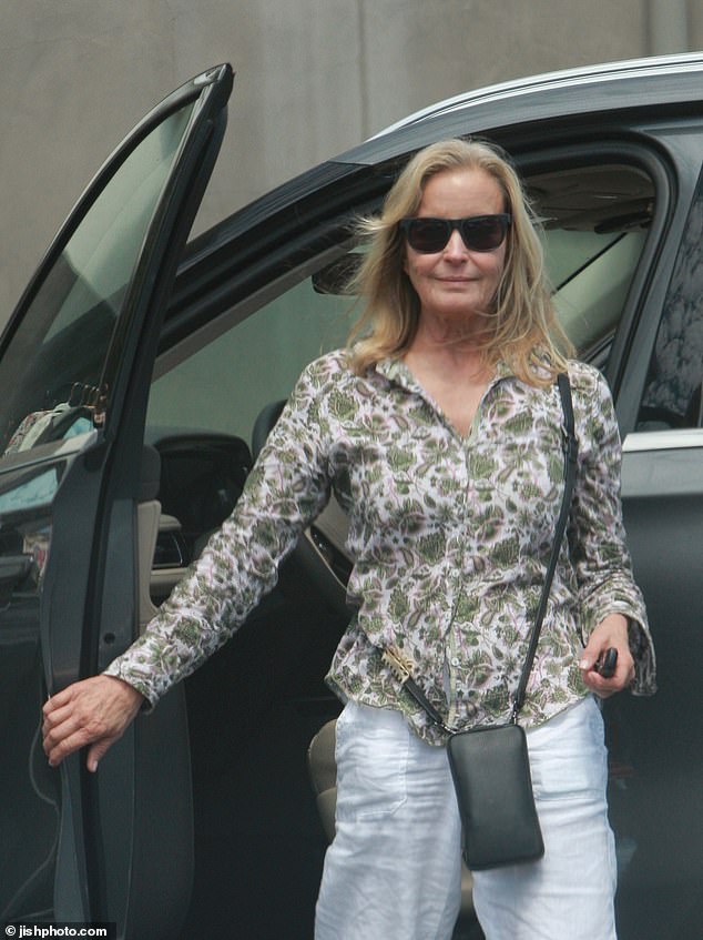 The petite blonde looked as fit and fabulous as ever, sporting a floral green blouse, white linen trousers and canvas sneakers, and dark sunglasses.