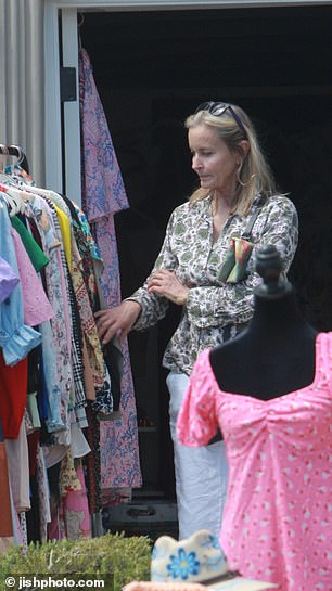 Bo was seen looking at a bright pink floral silk robe on a rack which she later purchased.