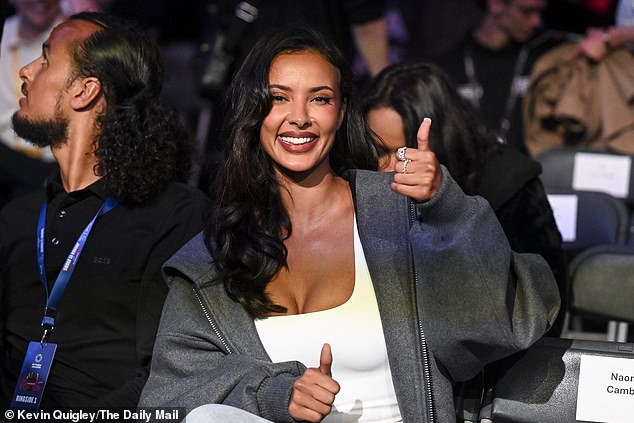 Combing her dark locks into loose curls, Maya flashed her gorgeous smile as she took her seat before the fight and gave the camera a thumbs up.