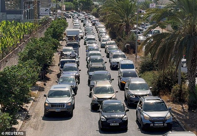 Vehicles flee north from the southern Lebanese coastal city of Sidon following Israeli shelling