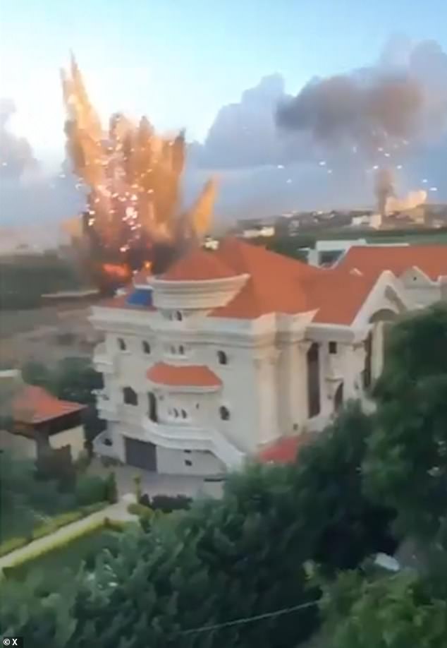 A large explosion is seen near a residential building in southern Lebanon