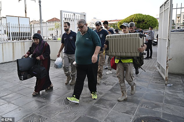 People who fled villages in southern Lebanon arrive at a makeshift shelter at an educational institution in Beirut