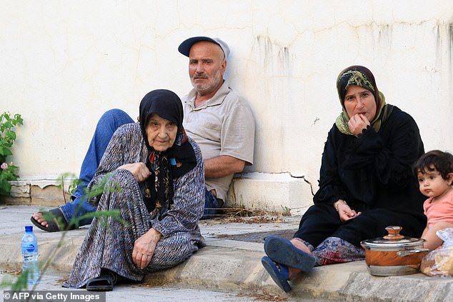 A Lebanese family, who fled their village in southern Lebanon, takes refuge in a public school in Sidon on September 23.