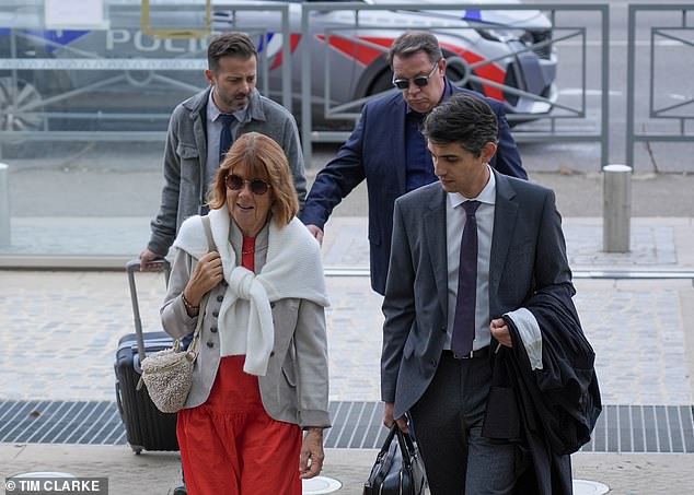 The 71-year-old woman arrives with her lawyer at the trial of her ex-husband and 50 other men accused of raping her