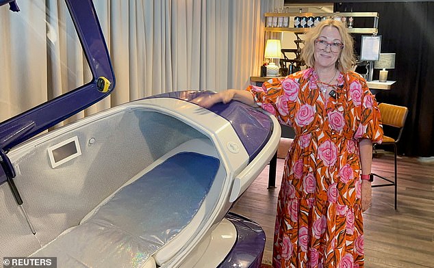 Last Resort cast member Fiona Stewart poses next to the Sarco suicide machine in July.