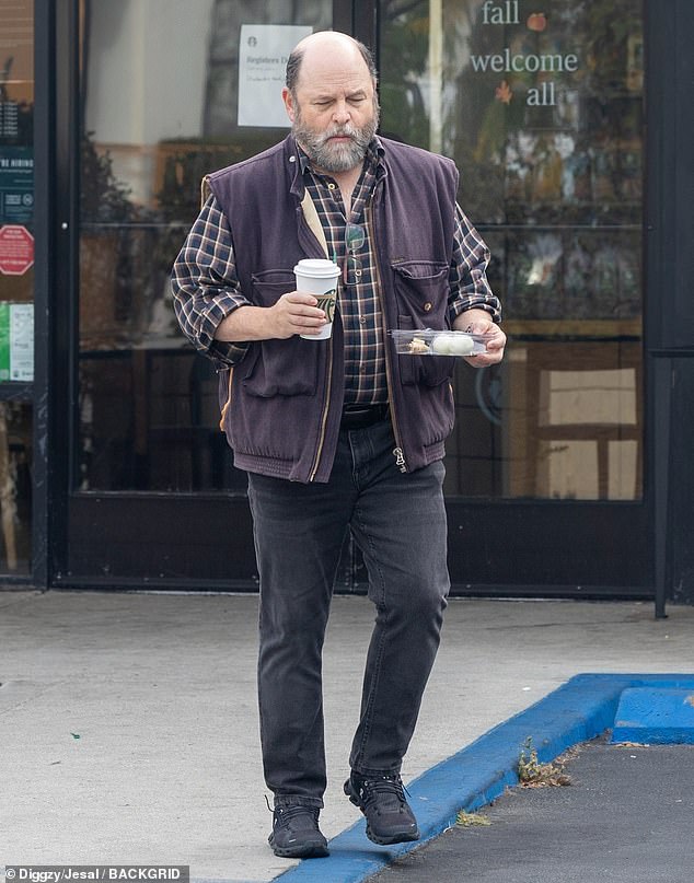 Alexander stepped out in Los Angeles in a pair of black pants and a button-front plaid shirt.