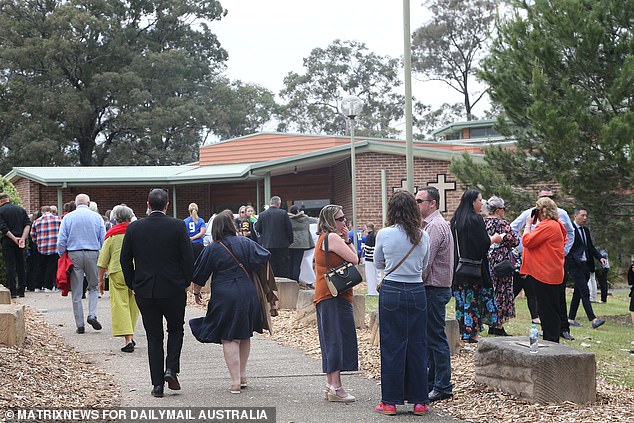 Mourners arrive at St. Thomas Aquinas Catholic Church in Springwood on Wednesday morning for the funeral of 11-year-old Russell and nine-year-old Ben.