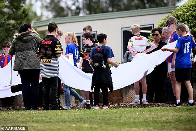 Young mourners are photographed at the funeral of Russell, 11, and Ben, nine, on Wednesday morning at St. Thomas Aquinas Catholic Church in Springwood.