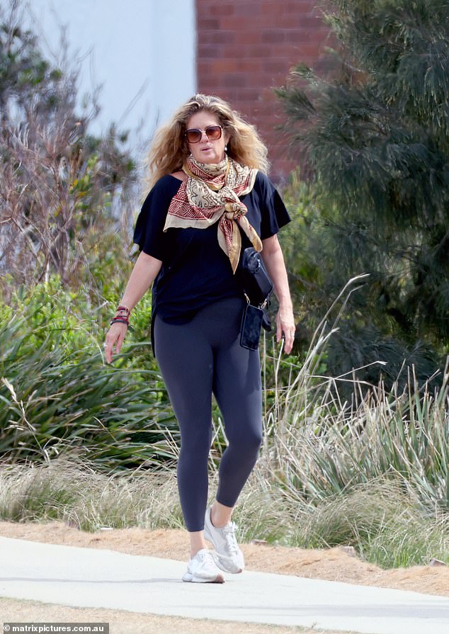 She also wore an assortment of colorful necklaces and a brightly patterned scarf tied around the strap of her bag.