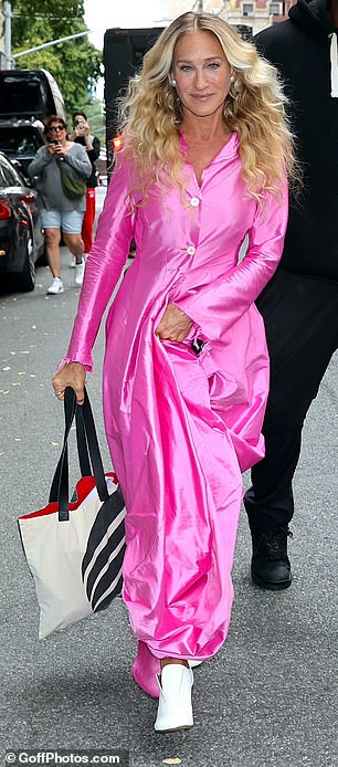 She accessorized her look with a black and white tote bag and chunky pearl earrings.