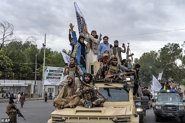 Taliban fighters celebrate one year since they took over the Afghan capital Kabul in front of the U.S. embassy in Kabul, Afghanistan, Monday, Aug. 15, 2022.