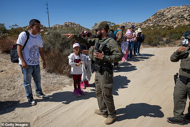 Border Patrol agents detain asylum seekers after they crossed a remote portion of the U.S.-Mexico border on Sept. 19, 2024 near Jacumba Hot Springs, California.