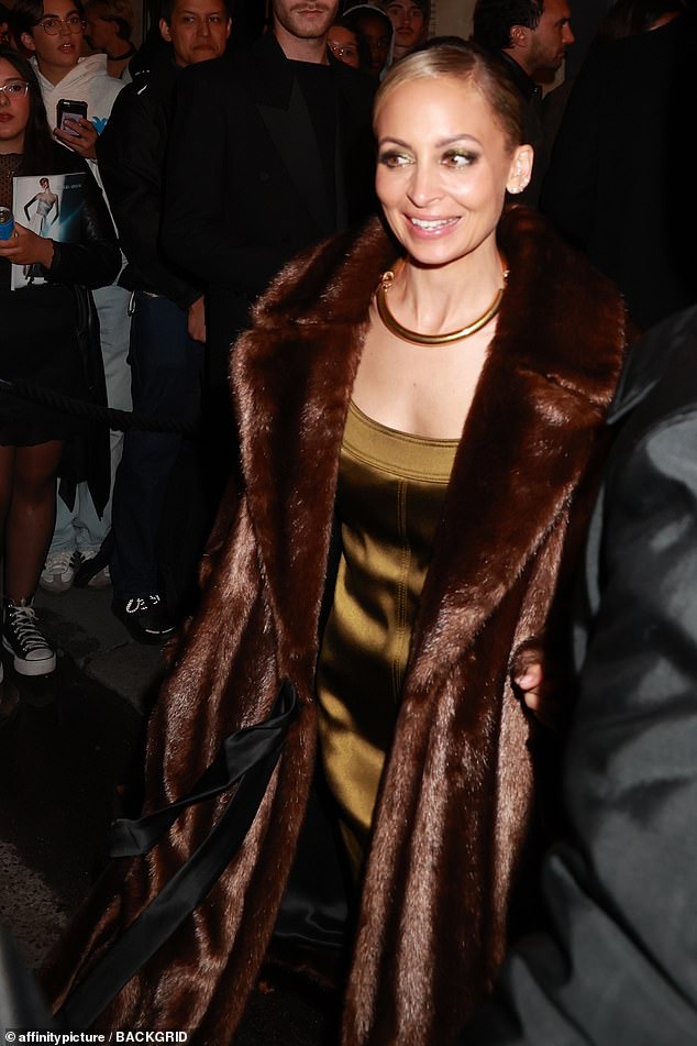 Nicole Richie, 43, looked chic in a plunging emerald mini dress and brown furry coat.