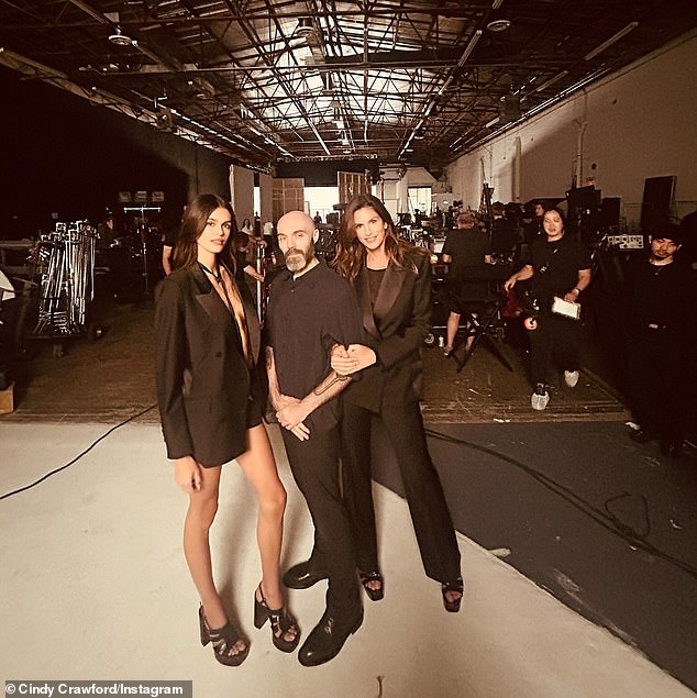 The 58-year-old '90s supermodel, who boasts 13.4 million followers on social media, showed off some behind-the-scenes photos from the set alongside director David Lowery (M), which were captioned: 