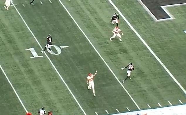 Kelce (below) celebrates a pass from Patrick Mahomes while turning his back on him in the clip