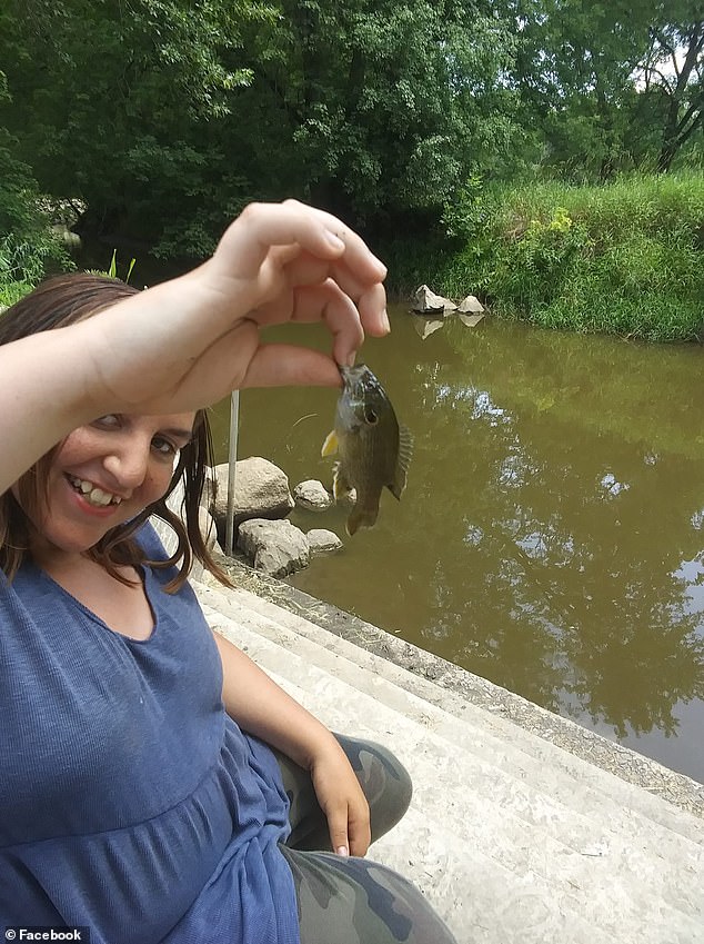 Jackson smiling after catching a fish