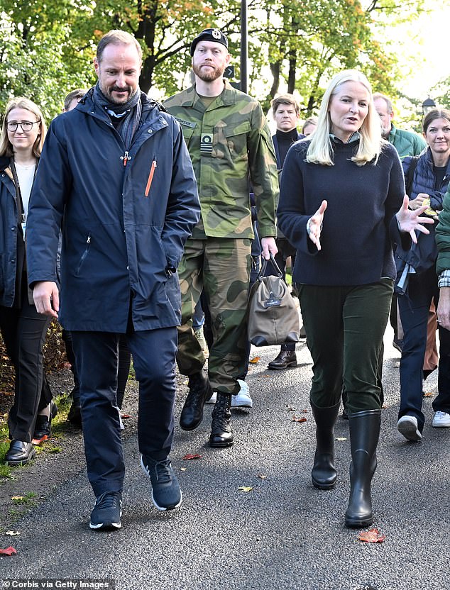 Crown Prince Haakon and Crown Princess Mette-Marit chatted with staff members as they walked around the farm.