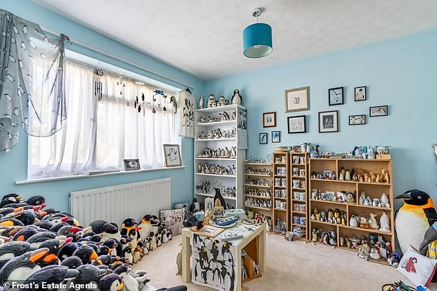 Hidden between snapshots of a perfectly adequate bedroom and bathroom is a bizarre room completely overrun by penguins.