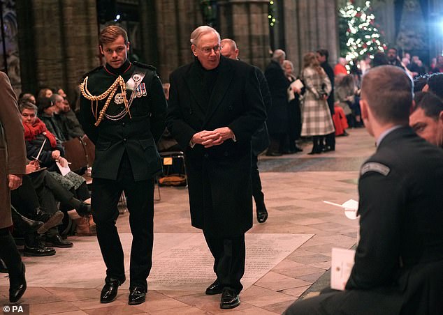 The 9th Lord Plunket's relative arrives for a carol service with the Duke of Gloucester in December 2022