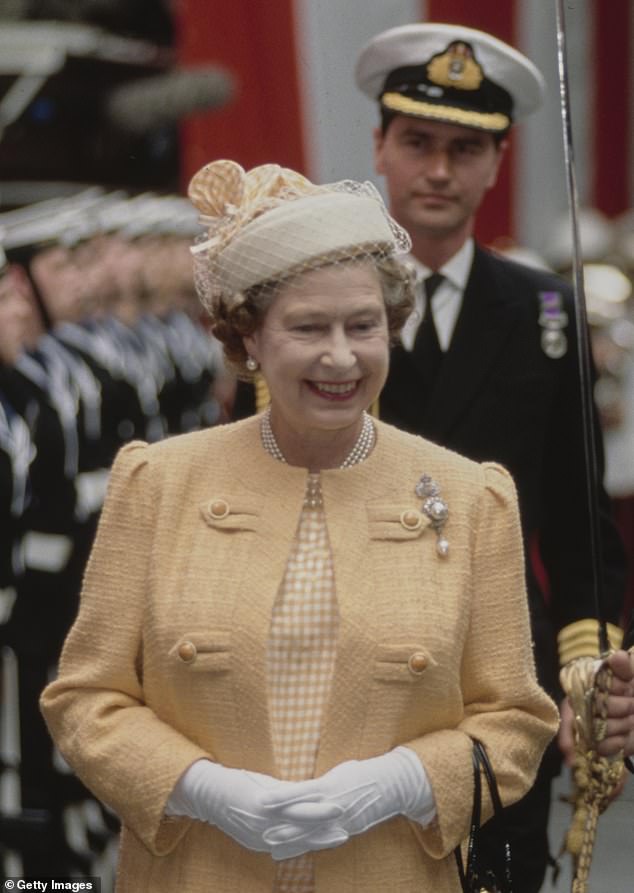 Commander Timothy Laurence walking behind the Queen at a commissioning ceremony for HMS Invincible in 1989