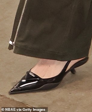 Clark was wearing black leather stiletto heels.