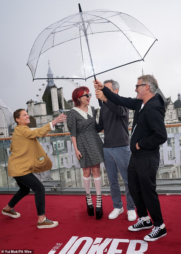 Stars protected from the rain under an umbrella