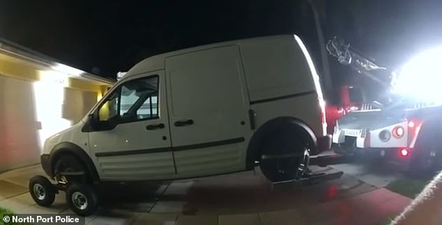 After the confrontation, the officer explains that the van is registered solely to Petito and that he is arranging for a tow truck to come and collect the vehicle. Pictured: Petito's SUV being towed away by North Port Police